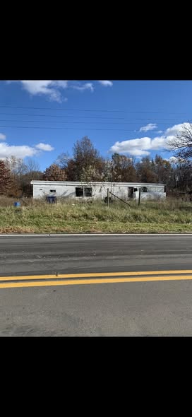 Abandoned mobile home on property before demolition and removal